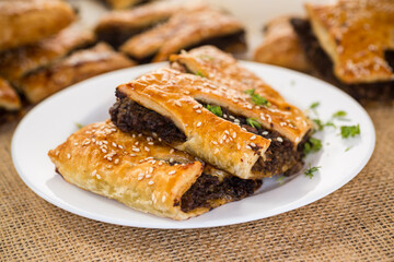 Golden puff pastries with mushroom filling and sesame seeds