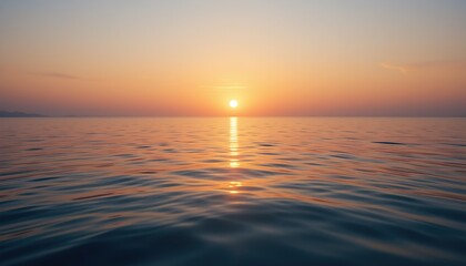 Fototapeta premium A serene sunset over a calm ocean, with the sun low on the horizon casting a golden reflection on the water. The sky transitions from warm orange to soft blue, creating a peaceful atmosphere