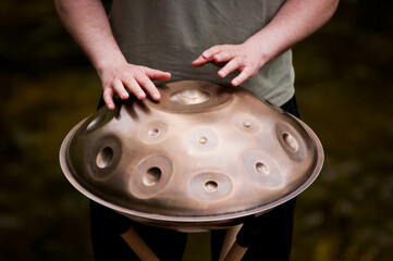 handpan outdoors near a waterfall