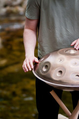 handpan outdoors near a waterfall