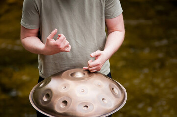 handpan outdoors near a waterfall