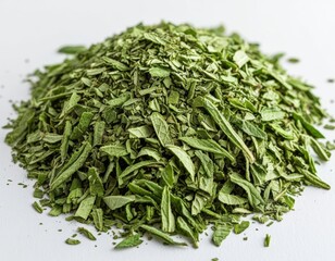 Crushed dried peppermint leaves in a natural pile on clean surface.