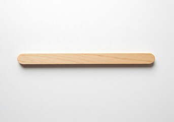 A single wooden craft stick with rounded ends laying flat on a white surface in a centered composition