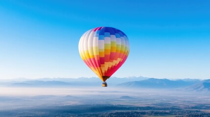 Fototapeta premium Colorful hot air balloon soaring above misty mountains