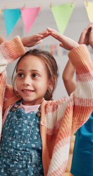 Dance, development and learning with kids in classroom at school together for rhythm. Choreography, education and music with happy student children at academy for growth, motor skills or scholarship