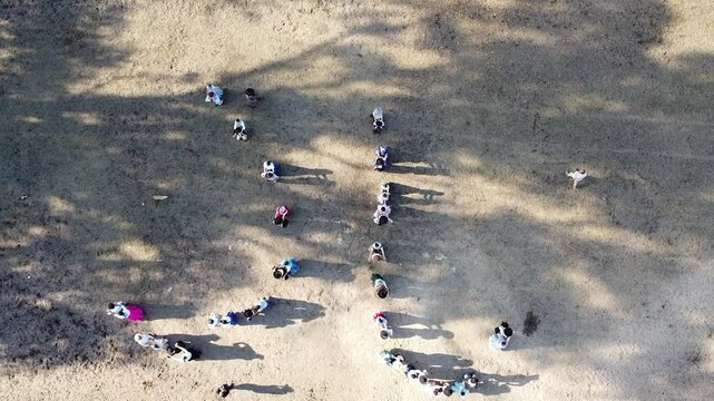 Video of Argentine chacarera dancers dancing in a circle, aerial view from a drone