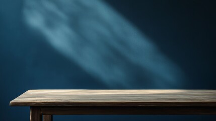 A blank table against a dark blue wall. Soft shadows and light add depth. Perfect to show off your products, like food or makeup.
