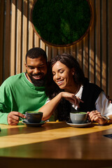 Joyful moments of an African American couple enjoying time together in a cozy cafe