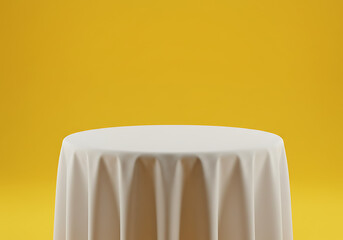Table covered with white cloth against a yellow background