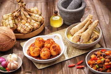 Ketupat Lebaran atau Eid Ketupat. The dishes served during Eid al-Fitr and Eid al-Adha are Ketupat, Opor Ayam, Telur Balado, Sayur Labu Siam, and Sambal Goreng Hati. Selective Focus .