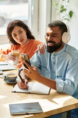 Couple collaborating and enjoying remote work together in a cozy cafe