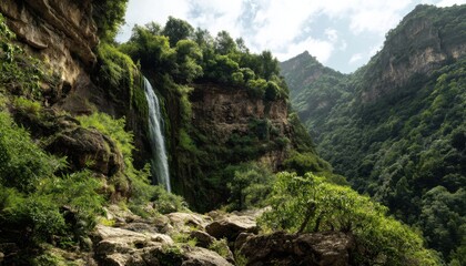 Obraz premium A cascading waterfall tumbles down the cliff, forming a beautiful natural wonder