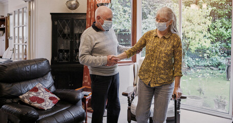 Elderly, couple and help or walking stick with mask, support or assistance on sofa in living room of home. Senior, man and woman with disability or cane in lounge of retirement with love and recovery