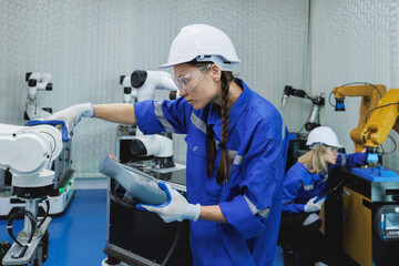 female automation machine engineer student study and inspection control robot arm machine in...