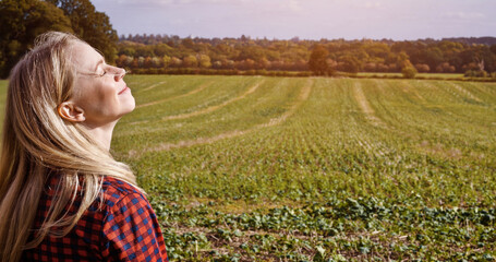 Breathe, smile and woman with eyes closed in countryside, nature or holiday travel, vacation or farm. Relax, happy person at field and calm, peace and summer freedom, fresh air and health or wellness