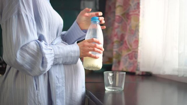 Mom-to-be savoring milk drink in peaceful home setting.