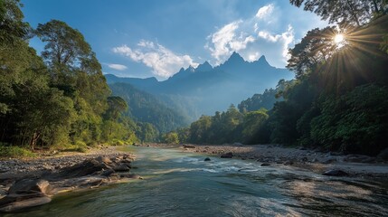 Mountain River Vista Captivating panoramic shot of a majestic mountain range, the river meandering through the lush green forest under a bright, cloud-speckled sky. The sun casts a warm glow.