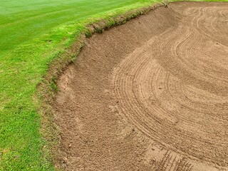 Golf Course Sand Pit Bunkers, green grass surrounding the beautiful sand holes is one of the most challenging obstacles for golfers and adds to the beauty of the golf course.