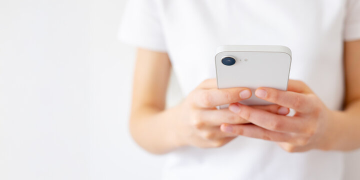 Girl Holding Phone in Hands and Typing