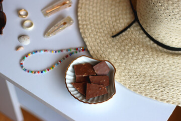 Glass of cocktail, straw hat, sunglasses, books, fresh fruit, chocolate and accessories. Summer...