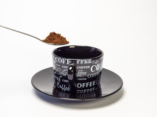 Coffee preparation with a spoon and cup on a white background