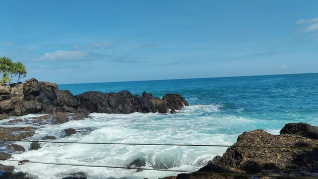4k footage of the waves of Menganti Beach in Kebumen Regency, Central Java Province. This beach is one of the beautiful beaches with large coral rocks and big waves.