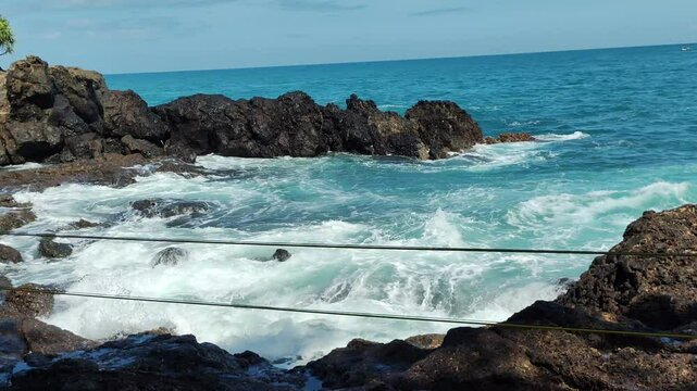 4k footage of the waves of Menganti Beach in Kebumen Regency, Central Java Province. This beach is one of the beautiful beaches with large coral rocks and big waves.