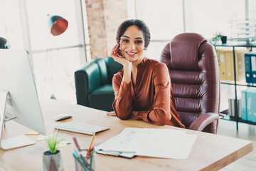 Professional businesswoman at work in modern office, daytime natural lighting, business setting...