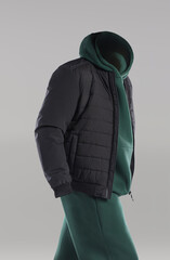 A black puffer jacket is layered over a green hoodie, creating a modern look ideal for outdoor...