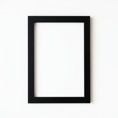 A simple black picture frame hanging on a white wall creating a minimalist and modern aesthetic look