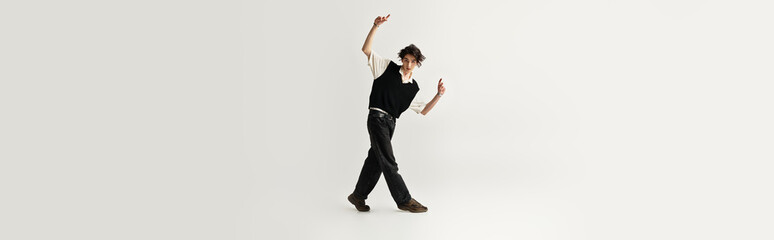 Stylish young man showcasing individuality in a bright modern studio