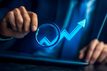 Close-up of a businessman's hands working on a laptop with a digital arrow graph and magnifying glass icon, a business process flow diagram illustration concept for an online market research .