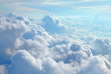 Fototapeta premium Fluffy white clouds with soft blue sky background, bright natural lighting, ideal for weather, nature, travel, or relaxation themes.