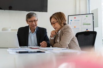 Senior businessmen analyzing data together.