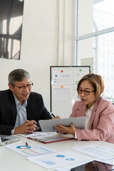 Senior businessmen analyzing data together.