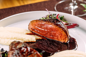 Portion of gourmet grilled beef steak with mashed potato and sauce