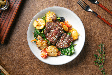 Portion of roast beef dish with vegetables garnish