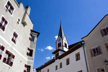 A charming upward view of the steeple of St. Virgil Parish Church in Rattenberg, Austria. The...
