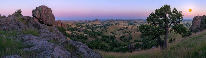 Obraz premium Wide panoramic view of a hilly landscape at sunset time