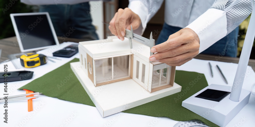 Aufkleber sustainability and design precision. architects using tools to ensure accuracy in a sustainable buil