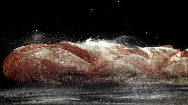 French rye baguette falls on the table. Filmed on a high-speed camera at 1000 fps. High quality FullHD footage