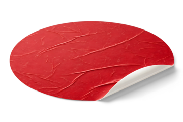 A close-up of a round red paper sticker with a slightly rough and textured surface on transparent or white background