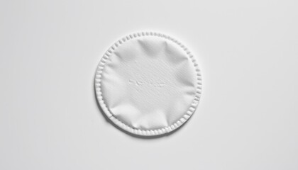 One reusable cotton makeup remover pad placed flat and centered on a pure white background (RGB 255,255,255), in a clean and slightly textured off white tone