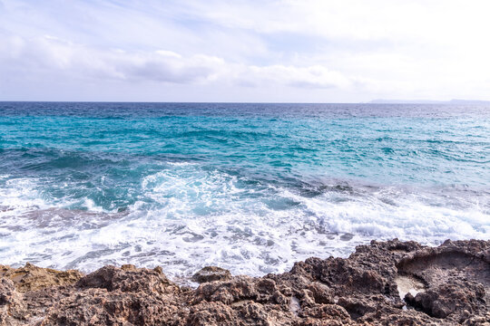 Coastal Waves Crashing Against Rocky Shoreline
