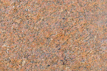 Polished granite texture, showcasing its beautiful texture and natural patterns. Stone features a blend of warm orange, brown, and black colors