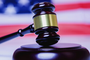 Judge gavel against United States national flag as symbol of judicial system of the USA. Justice,...