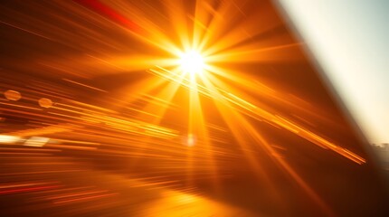 Abstract sunburst background, golden rays, motion blur, warm light, energy, speed.