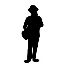 Silhouette of a man with a hat and shoulder bag standing still