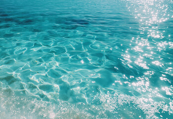 Crystal clear water surface reflecting sunlight in the ocean