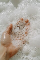 Fototapeta premium Hand in soapy bubbles